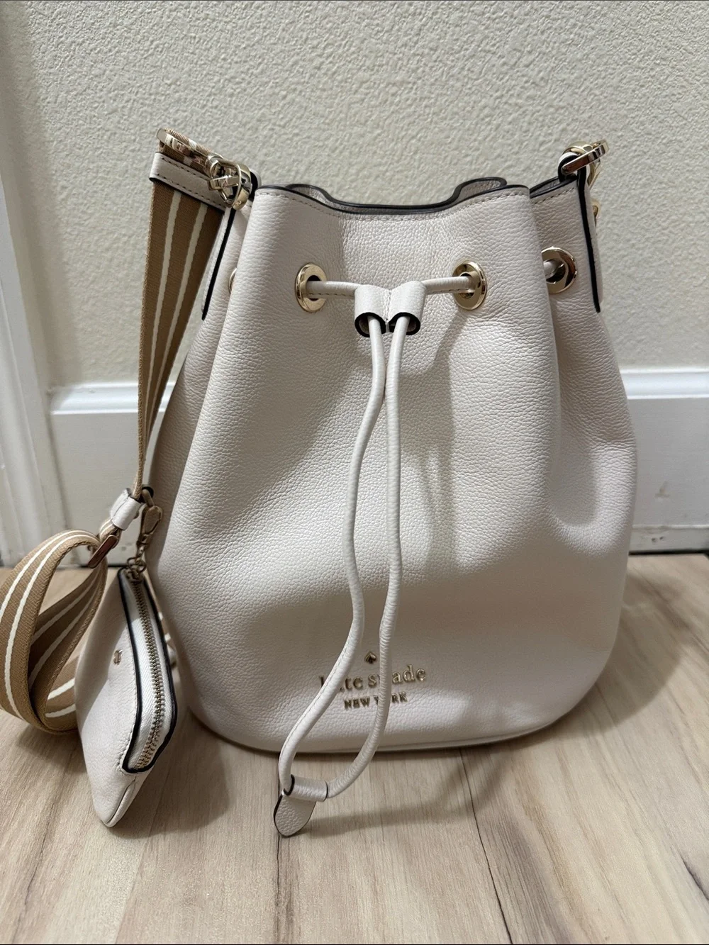 kate spade cream pebble leather drawstring bucket bag with striped tan strap